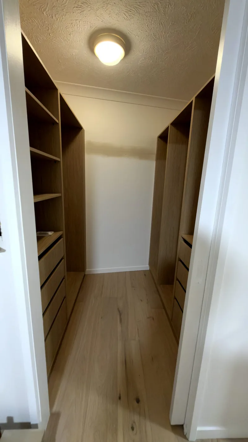 Oak walk-through wardrobe with shelving and drawers on both sides